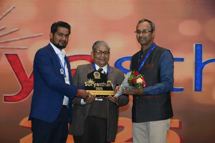 Suryasthan 2025 delegates presenting a commemorative memento on stage